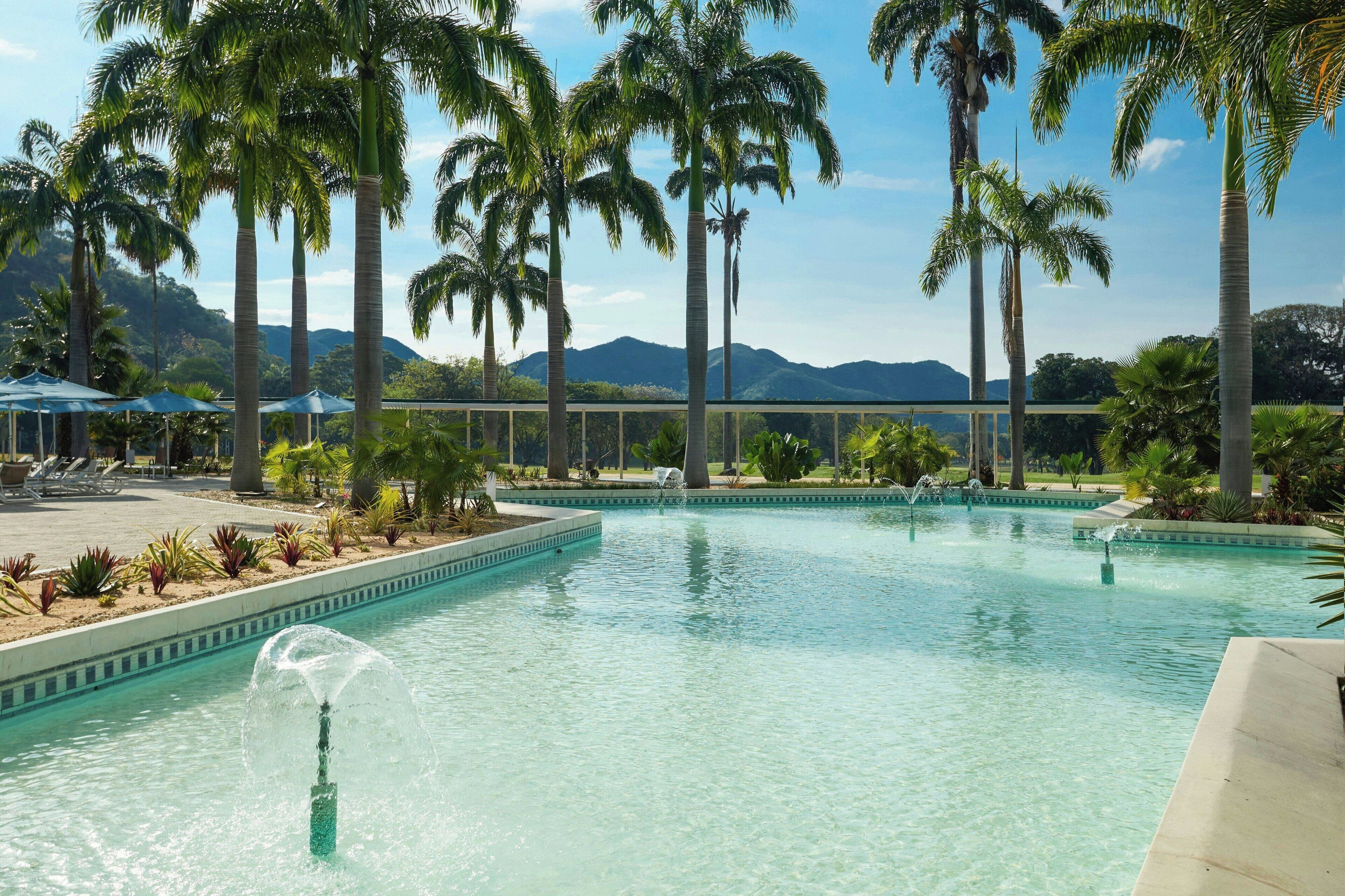 Outdoor pool, pool umbrellas, lifeguards on site