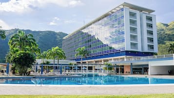 Outdoor pool, pool umbrellas, lifeguards on site