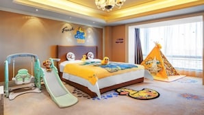 A child-friendly hotel room with a bed, a play area including a slide, a tent, and a wall with cartoon characters. - Juva Grand Hotel (Hohhot)