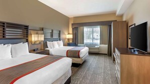 A hotel room with two beds, a TV, a desk, and a window with curtains. - Best Western Plus Heber Valley Hotel (Heber City)