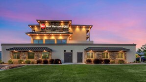 A modern hotel with a stone facade, a prominent sign, and a well-maintained lawn. - Best Western Plus Heber Valley Hotel (Heber City)