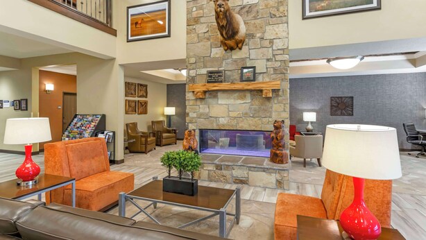 A spacious lobby with a stone fireplace, leather seating, and a mounted elk head. - Best Western Plus Heber Valley Hotel (Heber City)