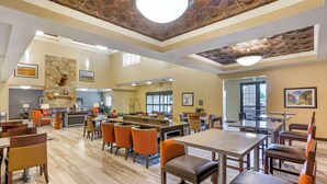 A spacious dining area with high ceilings, stone walls, and a variety of seating options including tables and chairs. - Best Western Plus Heber Valley Hotel (Heber City)