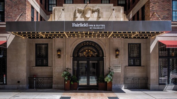 The exterior of Fairfield Inn & Suites by Marriott with a classic brick facade, arched entrance, and marquee lights. - Fairfield Inn & Suites by Marriott Philadelphia Downtown/Center City (Philadelphia)