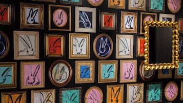 A wall of framed artwork featuring various rabbit designs.