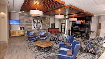 A modern living room with a fireplace, seating area, and entertainment system.
