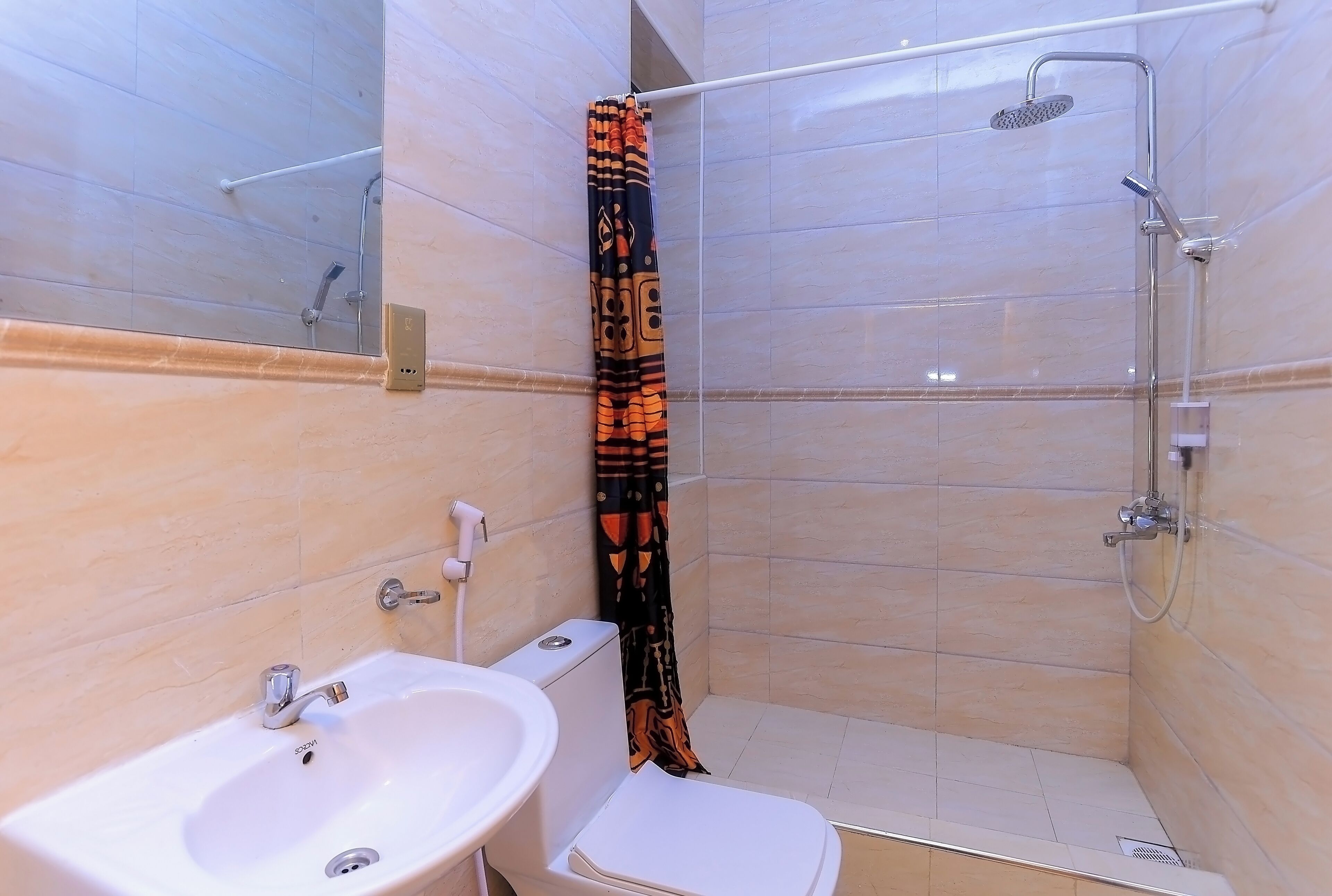 A bathroom with a shower, toilet, and sink.
