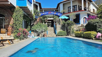 Alberca al aire libre y camastros