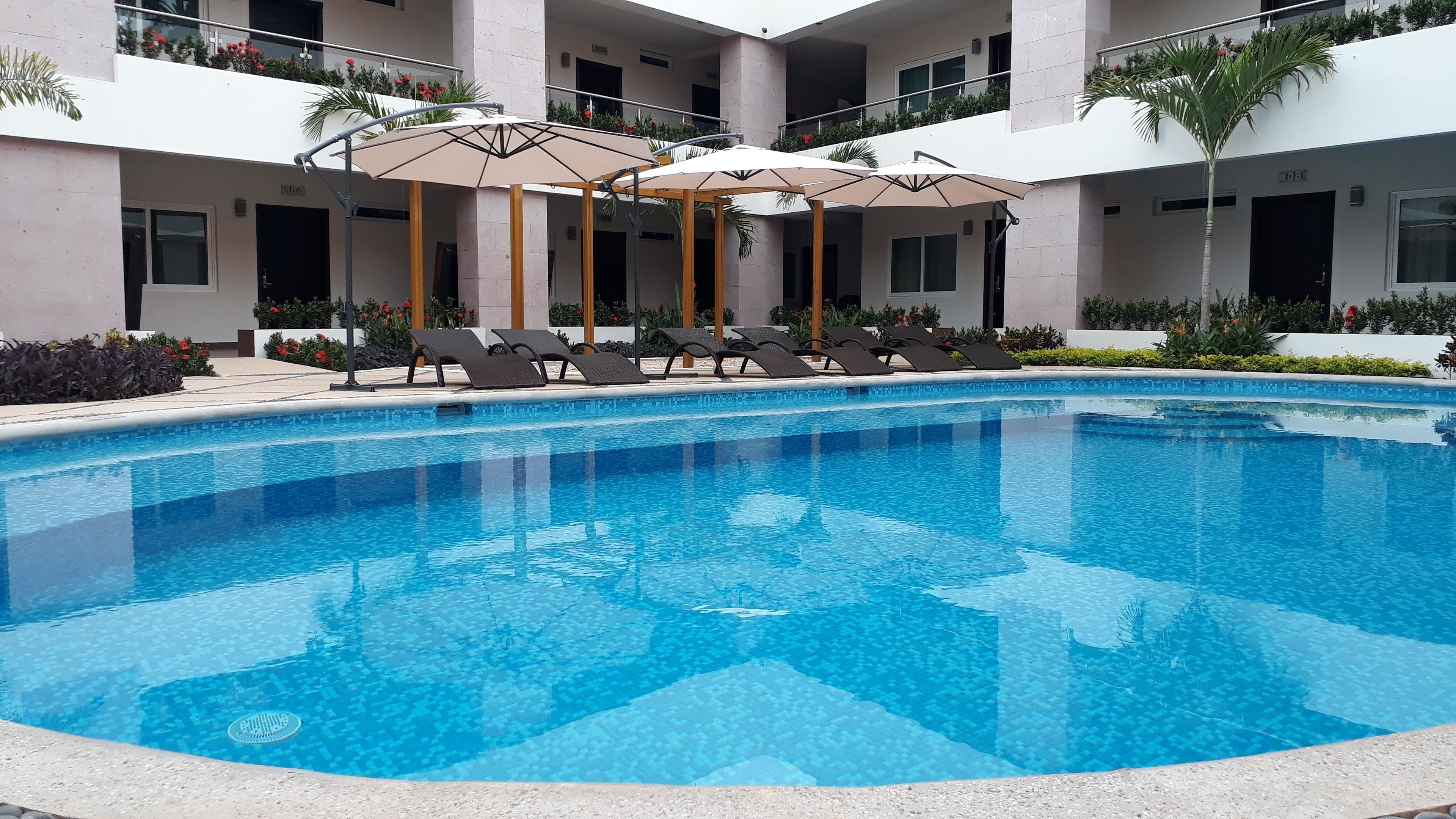outdoor pool, open 8 am to 8 pm, pool umbrellas, pool loungers