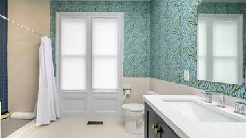 A bathroom with a white toilet, a white sink with chrome fixtures, and a shower area with a white curtain.