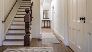 A staircase with wooden balusters leading to a landing. - Station Inn Pawling (Pawling)