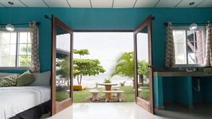 Une chambre avec un lit, une table et une vue sur la mer.