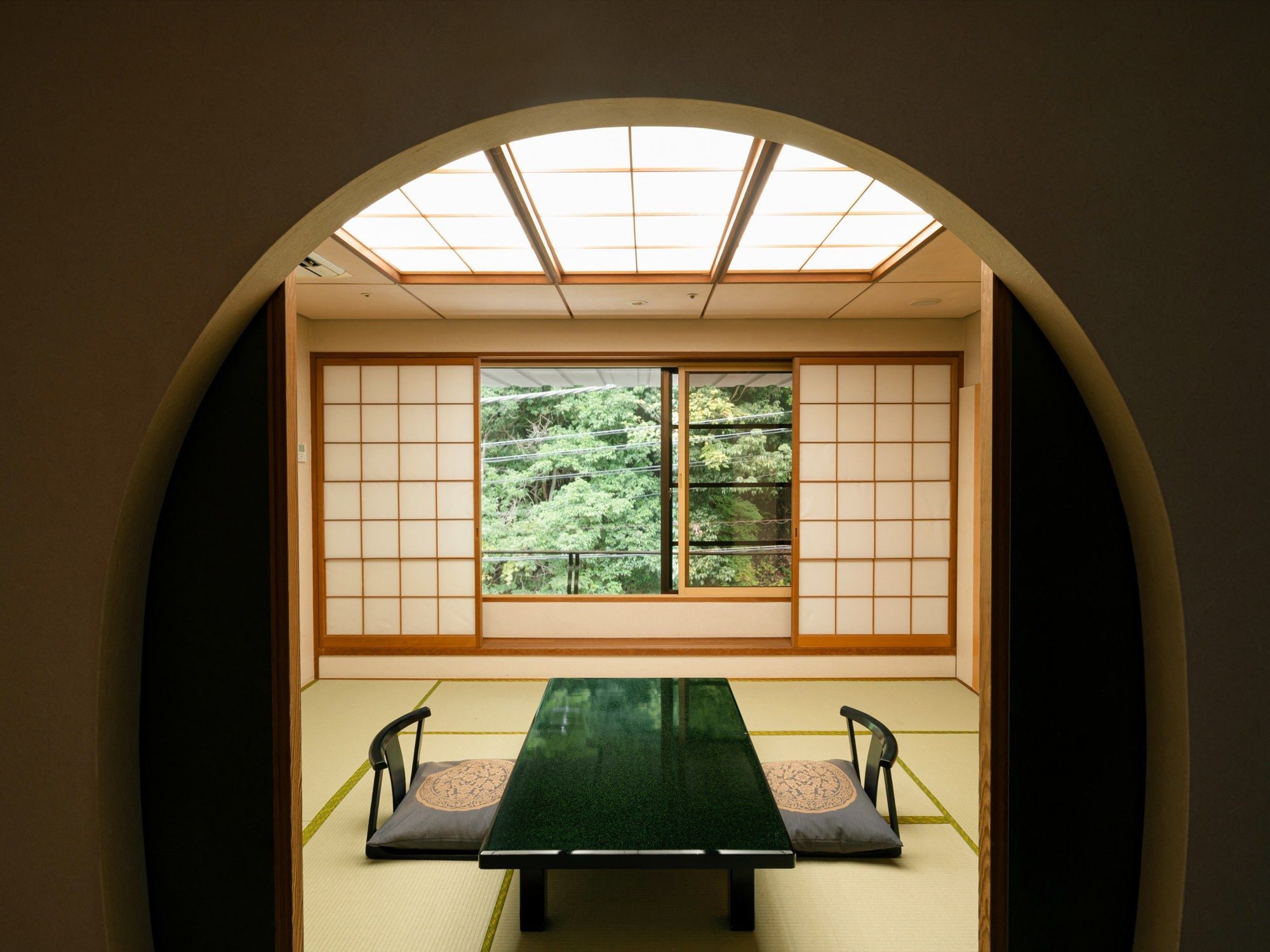 A traditional Japanese room with tatami flooring, a low table, and sliding shoji doors.
