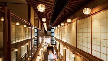 A corridor with traditional Japanese sliding doors and wooden beams.