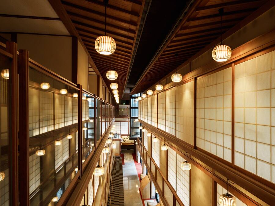 A corridor with traditional Japanese sliding doors and wooden beams.