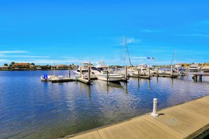 A marina with several boats docked at the piers. - Luxurious Esplanade Condo | Overlooking Bay (Marco Island)