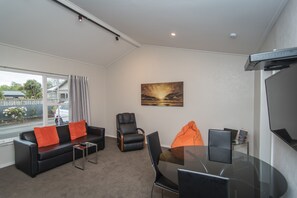 Two Bedroom Unit | Living area | 32-inch flat-screen TV with satellite channels, TV - Cedar Lodge Motel (Timaru)