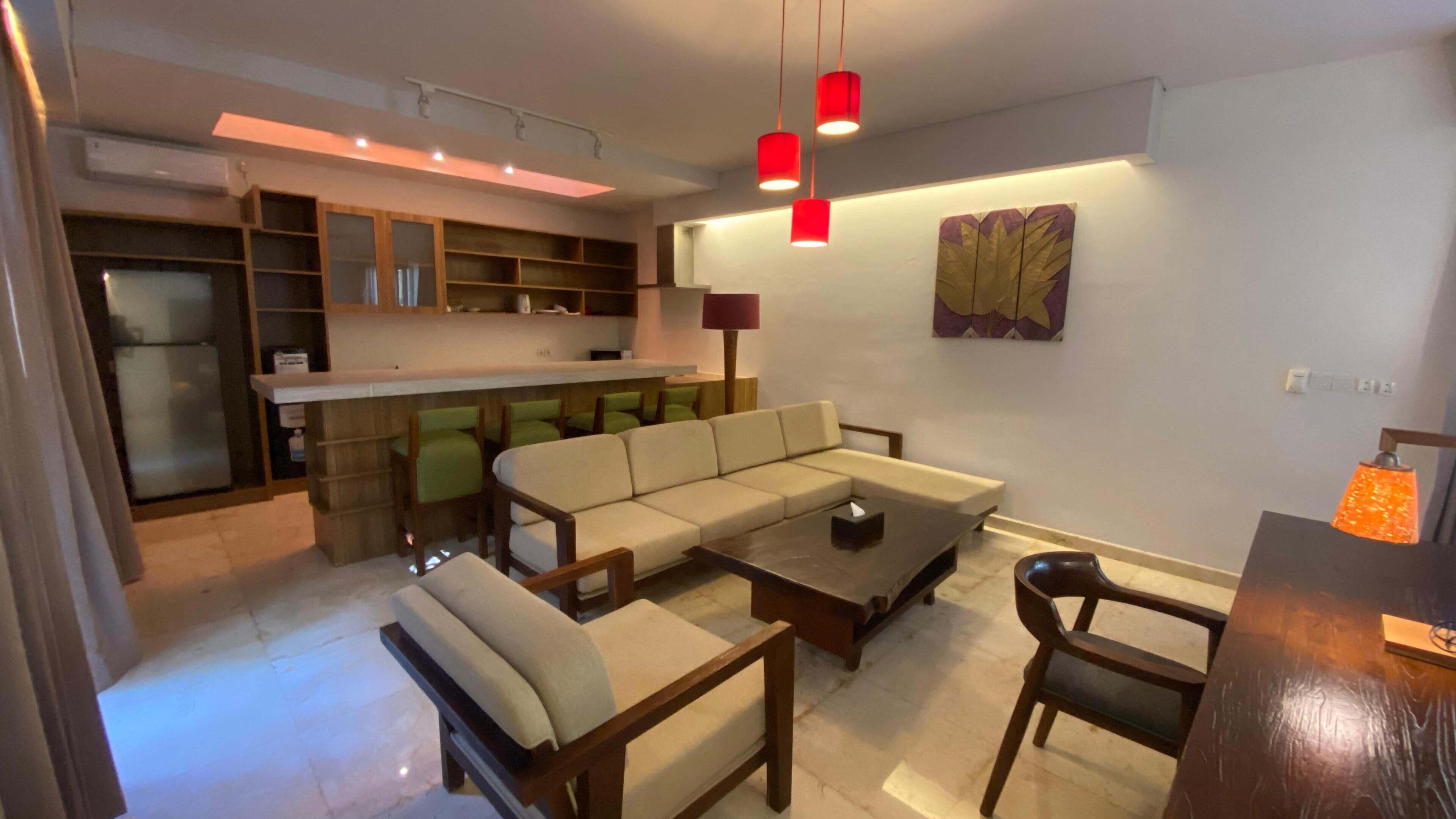 deluxe room, kitchen | living area | flat-screen tv