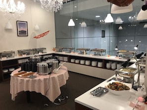 A buffet setup with various food stations, including hot and cold dishes, and a table with a pink tablecloth. - Fuji Mountain Resort Hotel (Fujikawaguchiko)