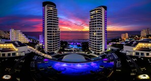 A high-rise hotel with a pool area and a sunset view. - The Capital Pearls (Umhlanga)