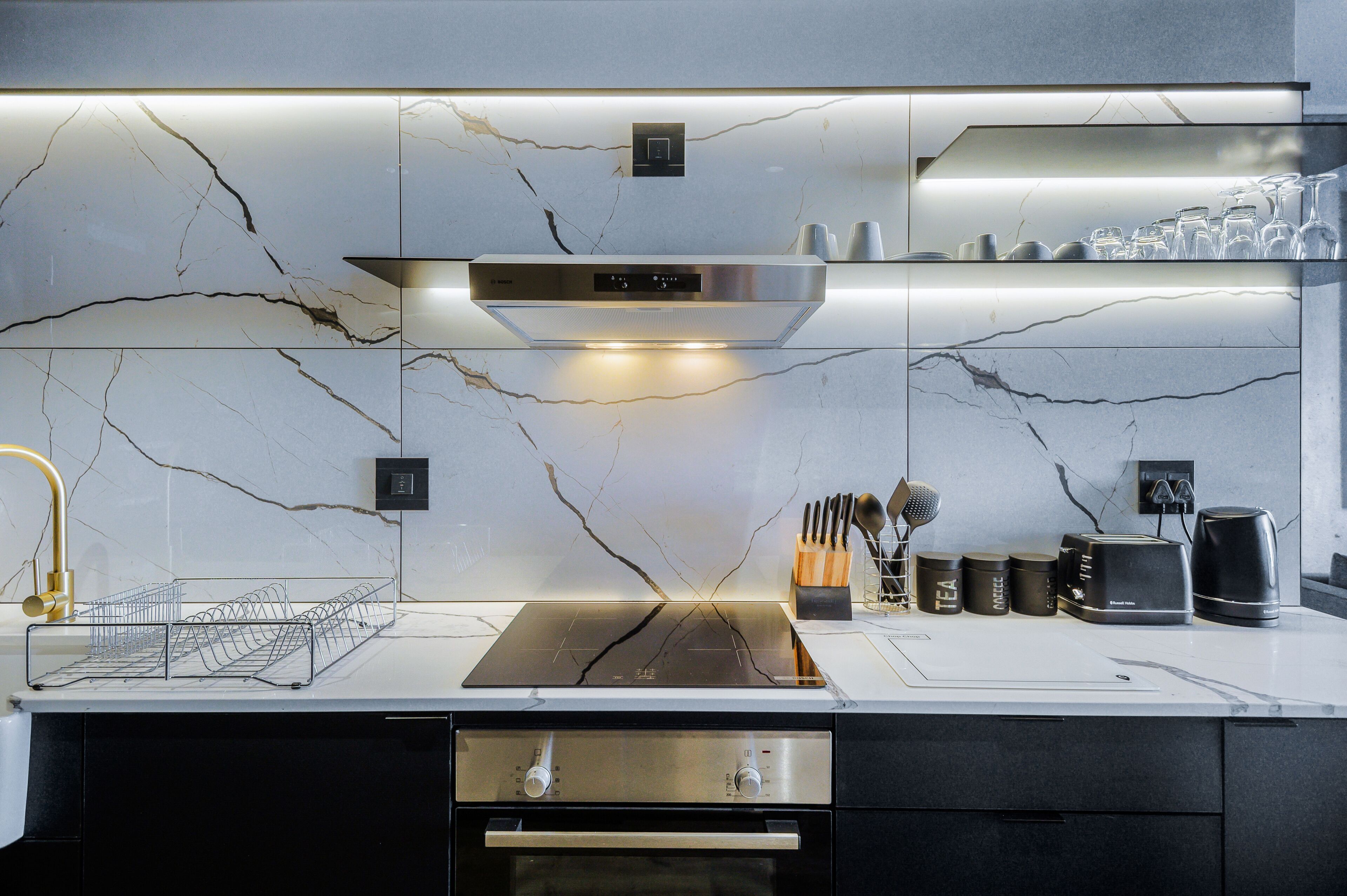 A modern kitchen with a built-in stove, oven, and microwave.