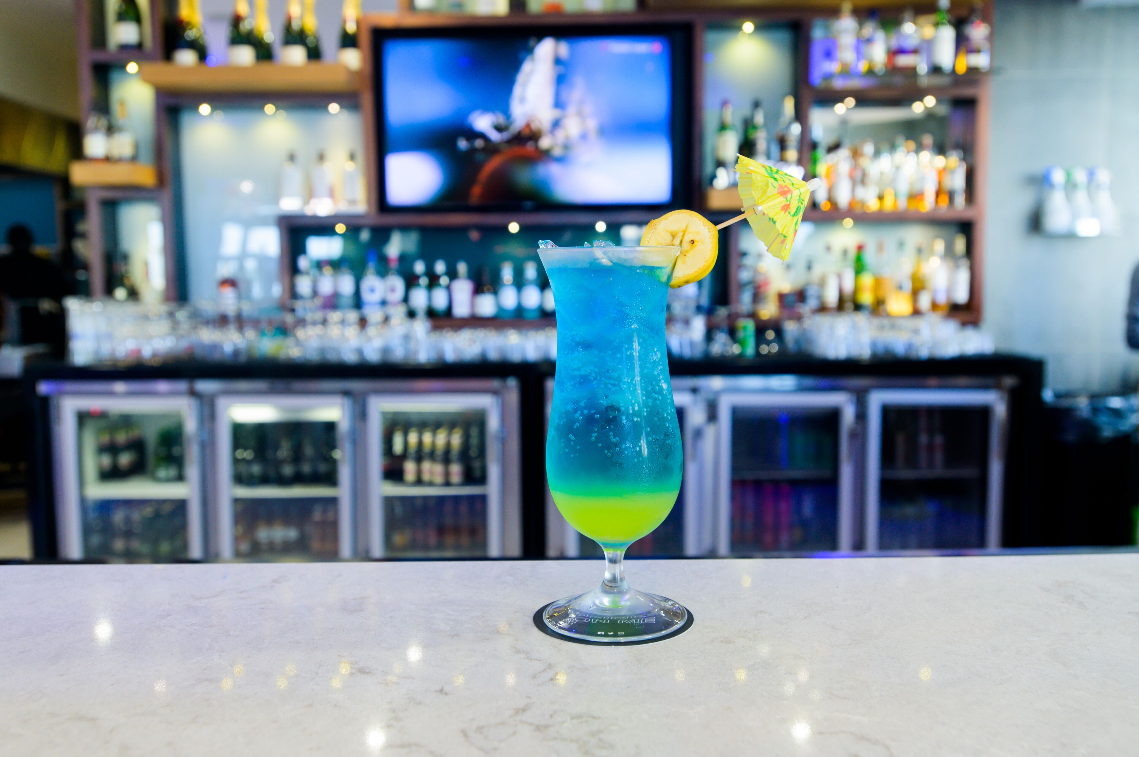 A bar setting with a cocktail on the counter.