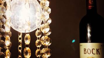 A bottle of Bock Royal Curves wine next to a decorative light fixture.