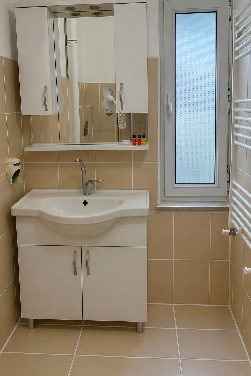 A bathroom with a sink, mirror, cabinets, and a window.