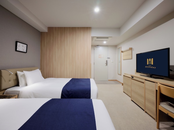 A hotel room with two beds, a TV, a desk, and a wardrobe. - Hotel MONday Haneda Airport (Tokyo)