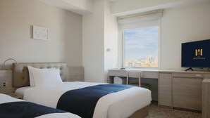 A hotel room with two beds, a desk, a TV, and a window with a city view. - Hotel MONday Haneda Airport (Tokyo)