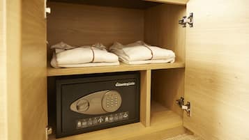A wooden cabinet with a safe containing a keypad lock.