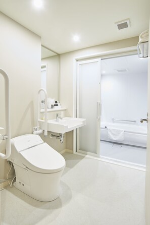 A modern bathroom with a toilet, sink, and shower area. - Quintessa Hotel Tokyo Haneda Comic & Books (Tokyo)