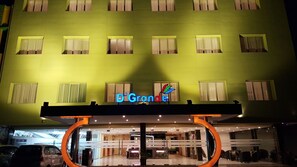 A hotel with a green facade, multiple windows, and a sign reading 'D'Grande.' - D'Grande Hotel (Batam)