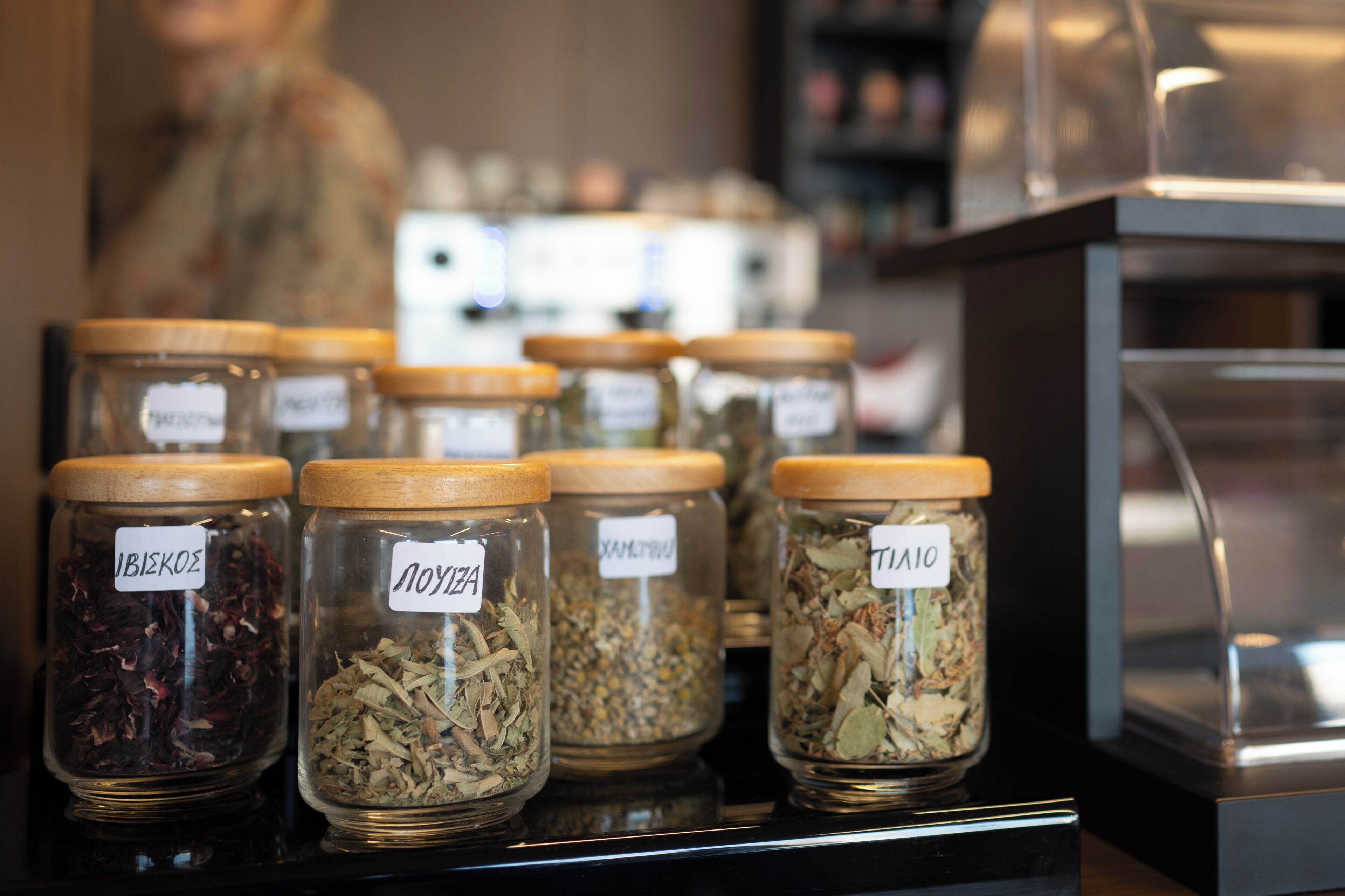 Glass jars with labels on a shelf.