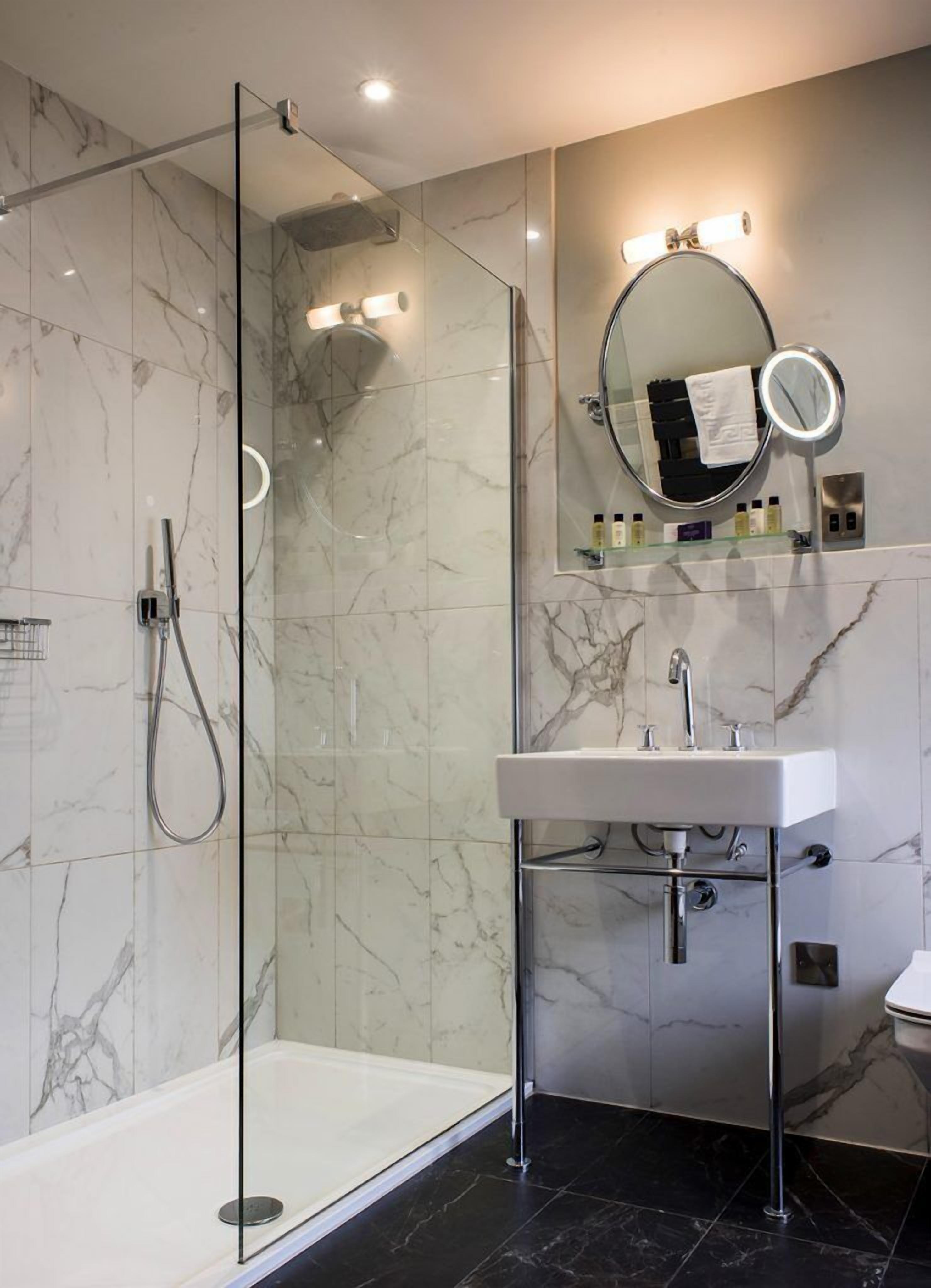 standard studio, 1 king bed | bathroom | shower, designer toiletries, slippers, towels