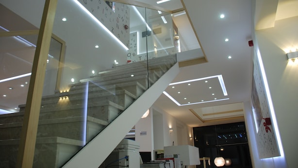 A modern interior with a glass staircase, recessed lighting, and a clean, minimalist design. - HOTEL LIBRIS boutique (Sarajevo)