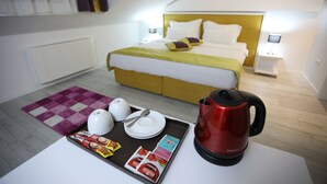 A hotel room with a bed, bedside tables, a tray with breakfast items, and a kettle. - HOTEL LIBRIS boutique (Sarajevo)