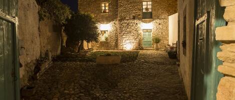 A stone building with a courtyard at night.