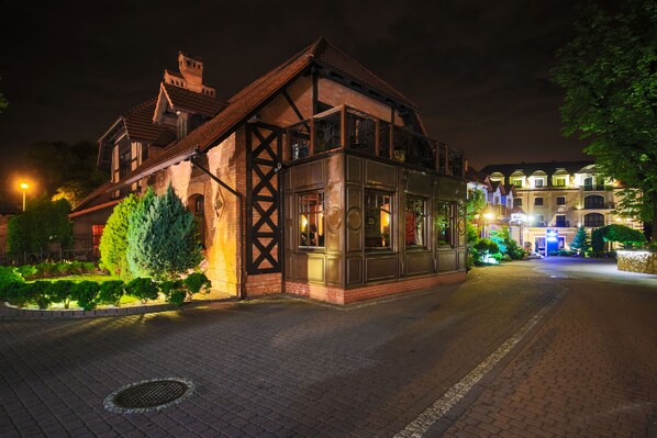 A traditional building with a prominent wooden facade and a large glass window section, likely a hotel or historic building. - Hotel Galicja Wellness & SPA (Oswiecim)