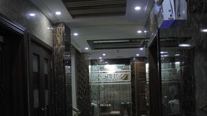 A corridor with a patterned floor, a reception area, and a sign for 'BARO RESTAURANT'. - Zimbo Golden Hotel (Dar es Salaam)