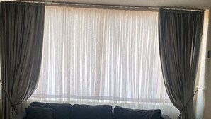 A room with a bed, a sofa, a small table, and a window with curtains. - Masal Otel (Izmit)