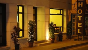 A hotel entrance with a sign reading "MADABA HOTEL" and potted plants in front. - Madaba Hotel (Madaba)