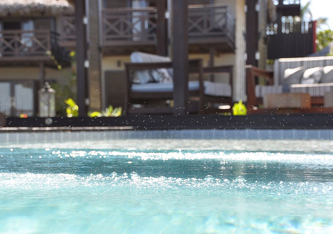 A swimming pool with a view of a resort building in the background.