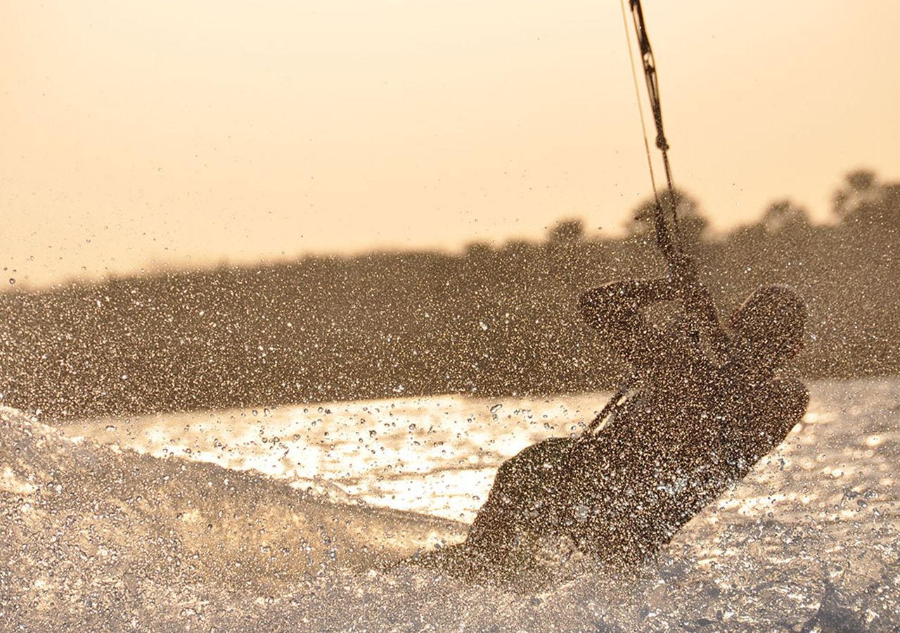 A person windsurfing on a body of water.