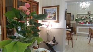 A dining area with a table, chairs, and a chandelier. - Hotel Stipino (Lucca)