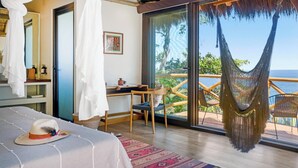 A room with a bed, a desk, and a hammock.