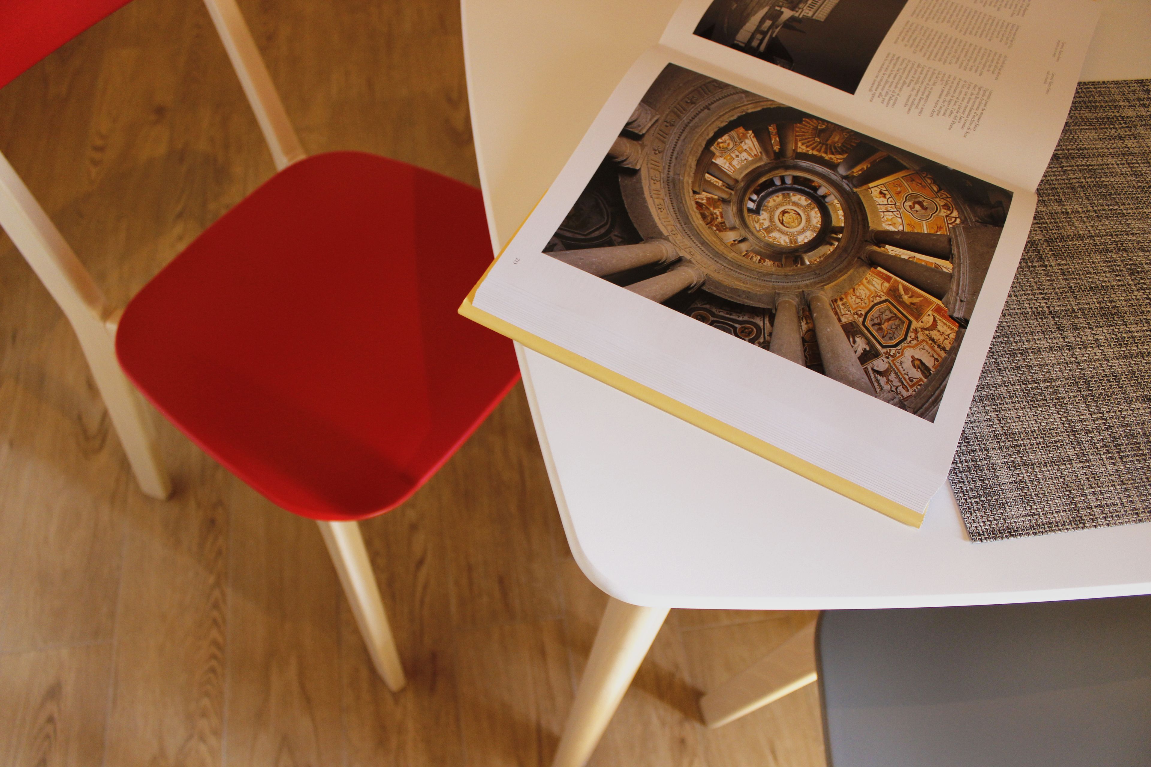 A book with a detailed illustration of a mechanical device on a table.