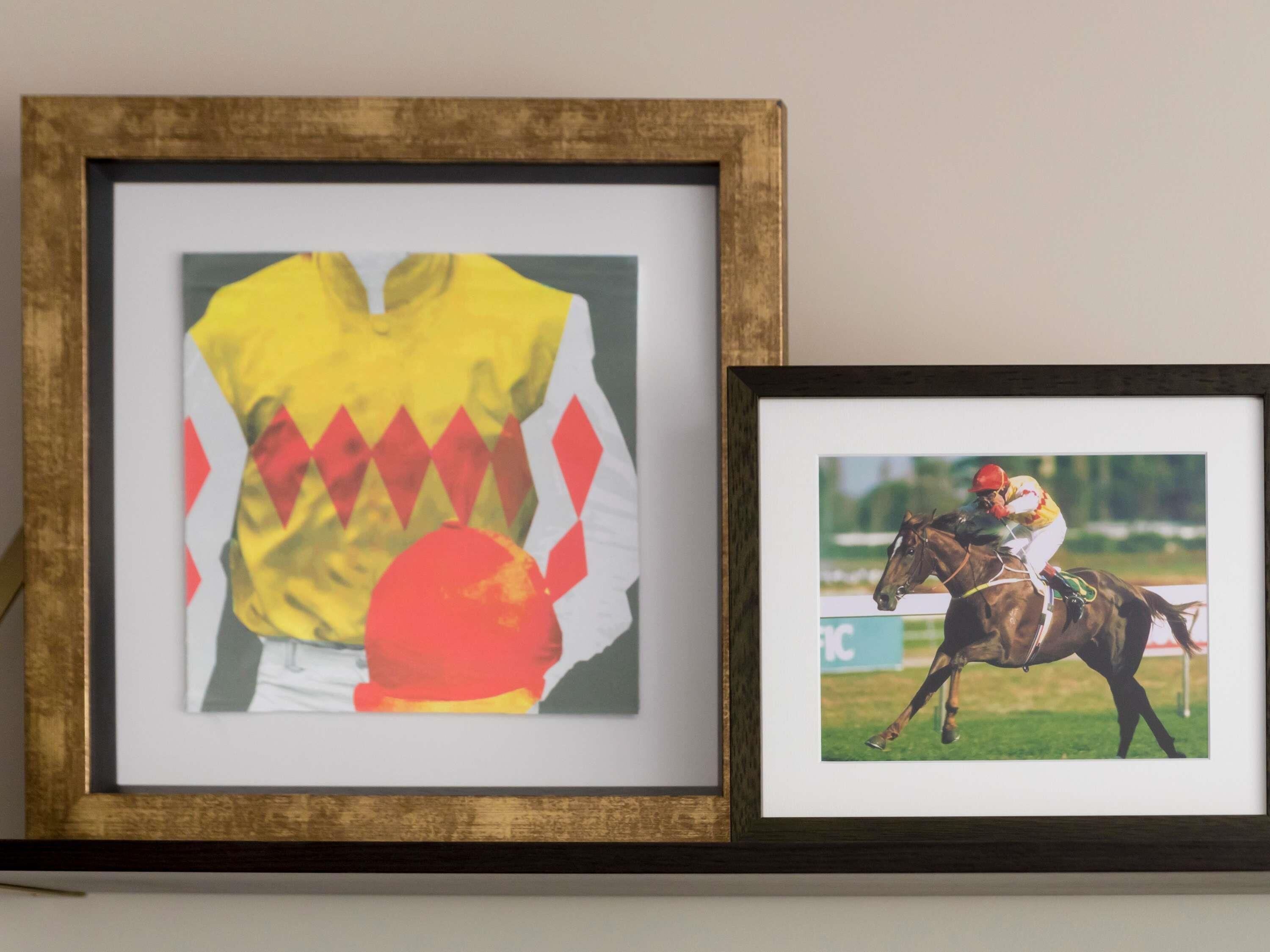 Two framed photographs, one of a jockey and horse, and another of a jockey and horse in a race.