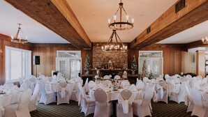 A banquet hall with round tables set for a wedding reception, featuring a wooden ceiling and a stone fireplace. - Rawdon Golf Resort (Rawdon)