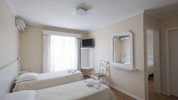 Deluxe Quadruple Room | Minibar, desk, blackout drapes, iron/ironing board